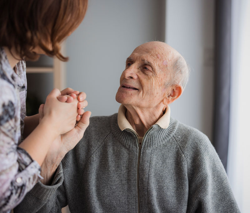 Elderly-man-looking-at-his-daughter-with-love Elderly man looking at his daughter with love