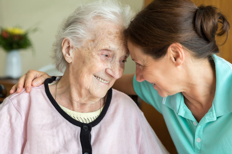 Senior-Woman-and-Home-Caregiver Senior Woman and Home Caregiver smiling together